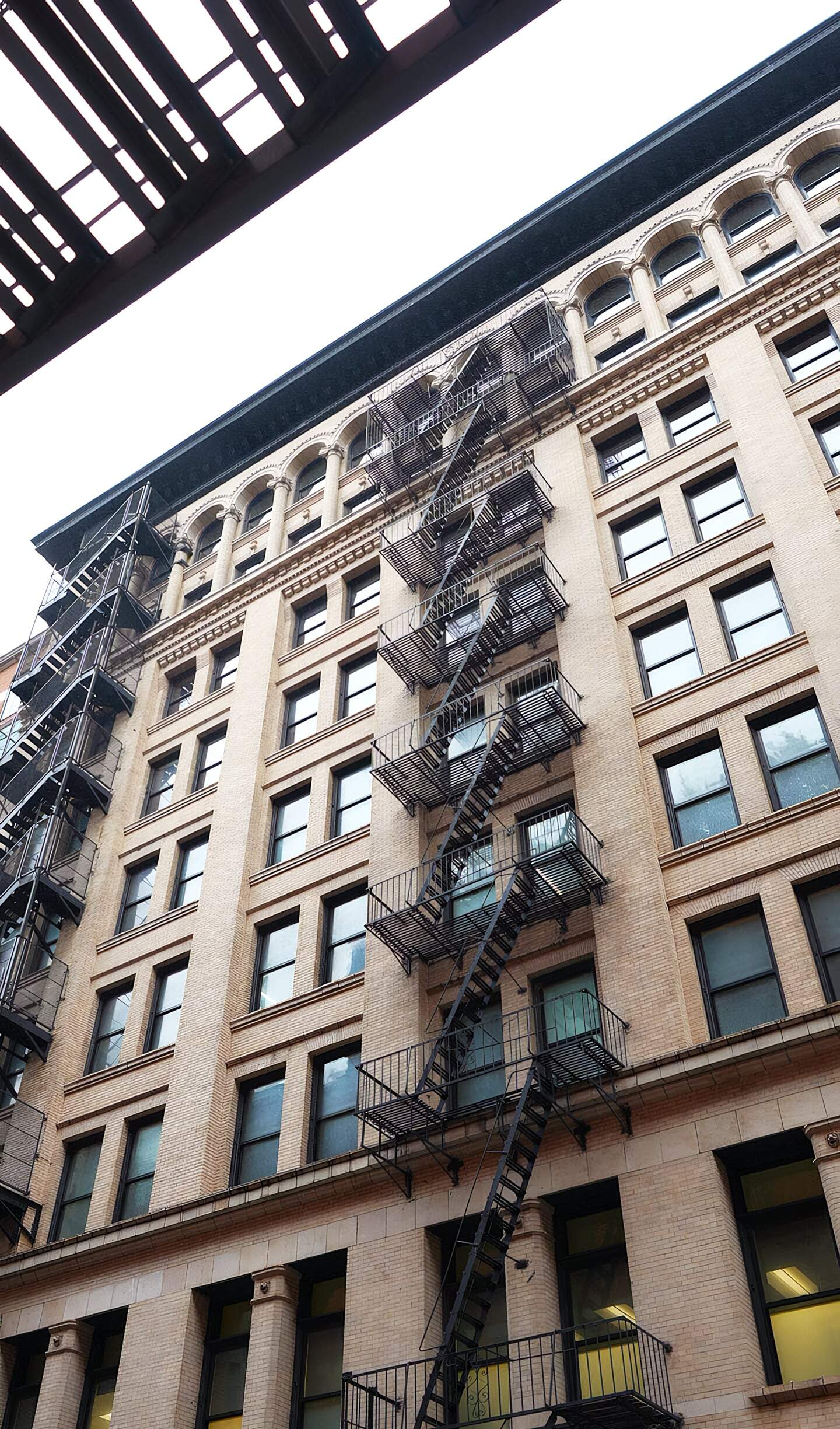 Untitled Building With Fire Escape Stairs On The Exterior, Showcasing Urban Construction And Renovation By American Builders.