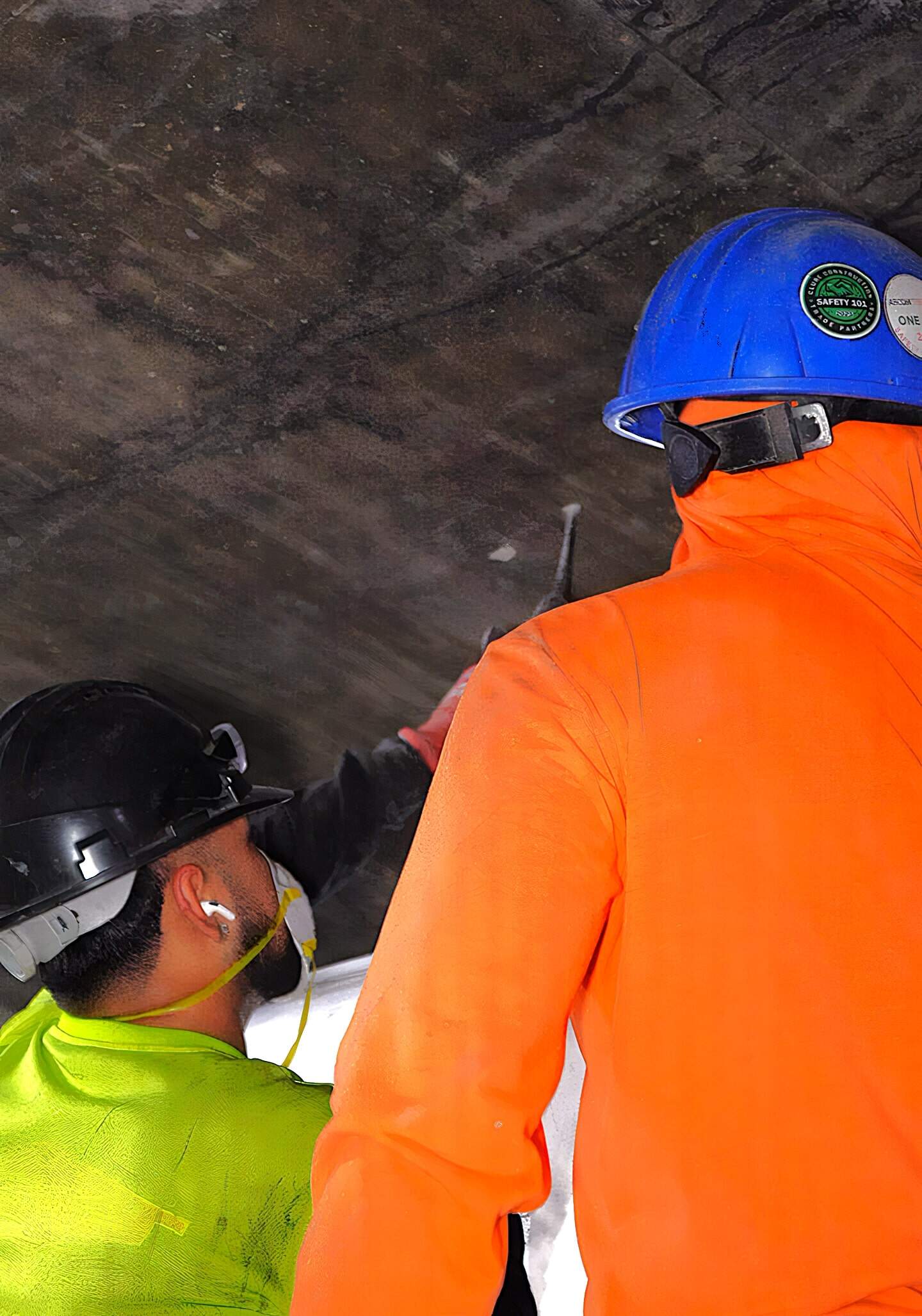 Professional Construction Workers Wearing Safety Helmets And High-Visibility Jackets Working On A Construction Site For American Builders.