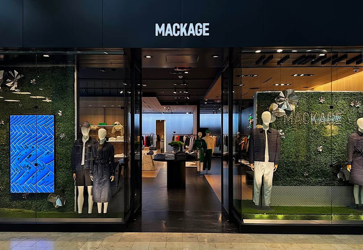 Blue Storefront Window Display Of Clothing At Joining American Builders Boutique Shopping Retail Store.